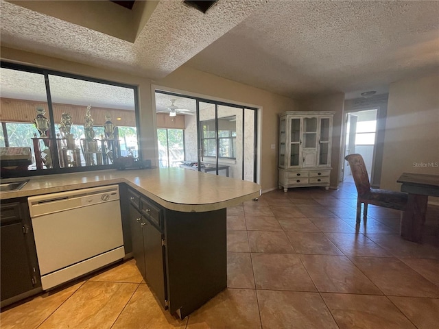 kitchen with dishwasher, ceiling fan, kitchen peninsula, and a textured ceiling