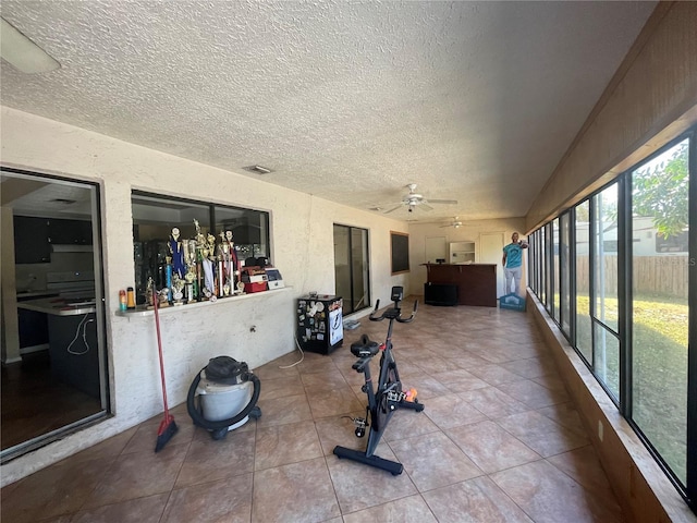 sunroom / solarium featuring ceiling fan