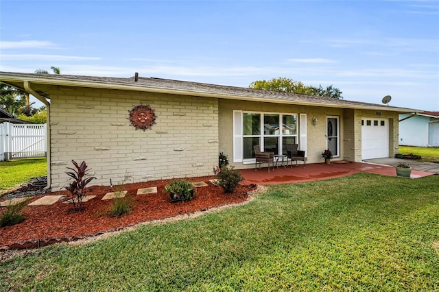 ranch-style home with a front yard and a garage