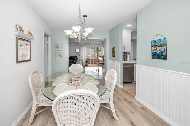 dining space with an inviting chandelier and light wood-type flooring