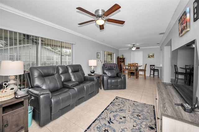 living room with ornamental molding, a textured ceiling, and light tile patterned floors