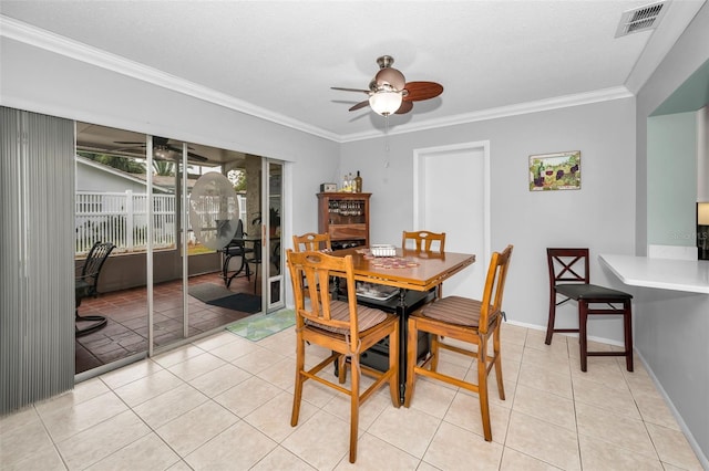 dining space featuring ceiling fan, ornamental molding, a textured ceiling, and light tile patterned floors