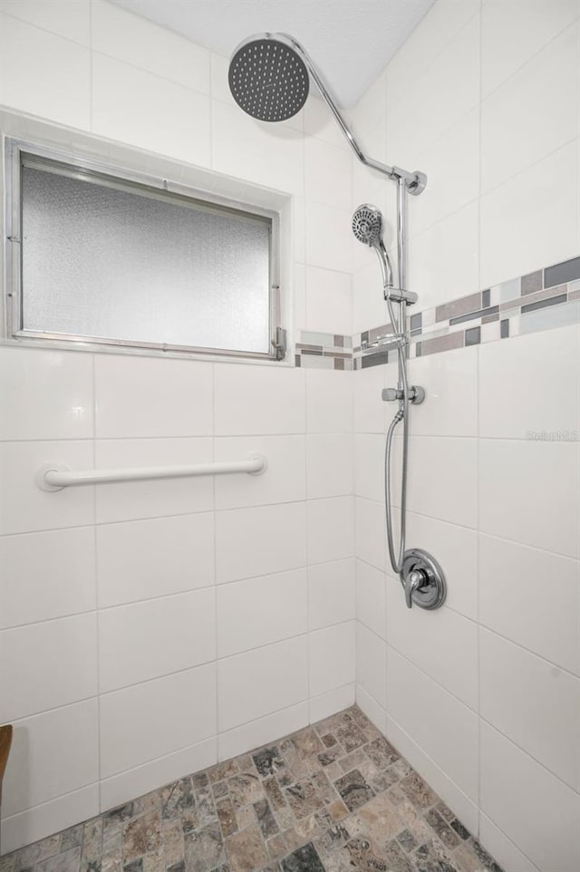 bathroom with a tile shower