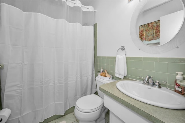 bathroom featuring tile patterned flooring, vanity, tile walls, and toilet