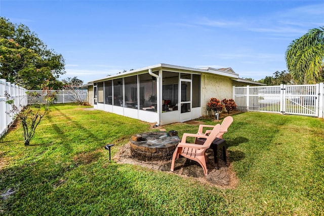 back of property with a yard and a sunroom