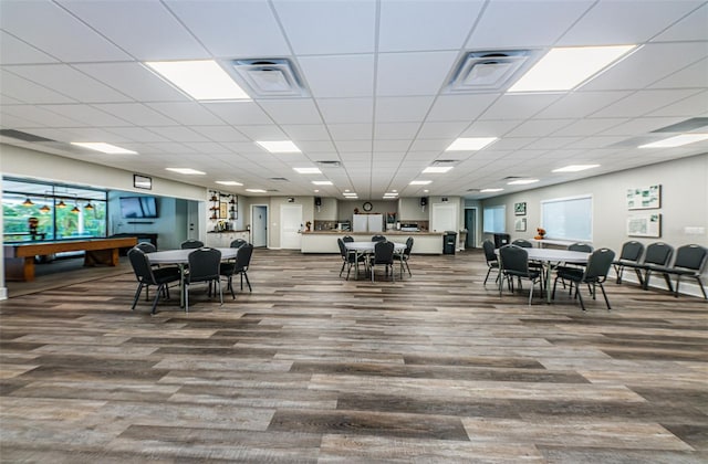 dining area with hardwood / wood-style flooring and a paneled ceiling