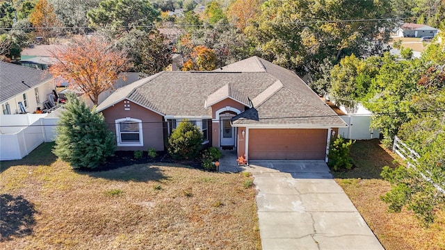 view of front of home featuring a garage and a front lawn