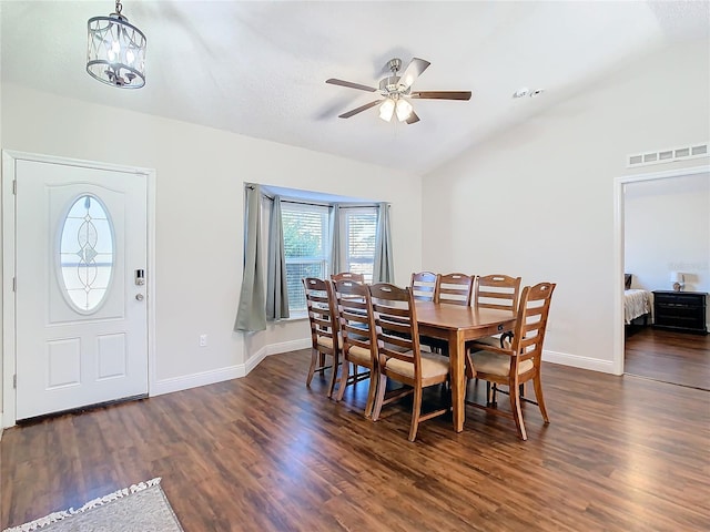 dining area with ceiling fan with notable chandelier, dark hardwood / wood-style floors, and lofted ceiling