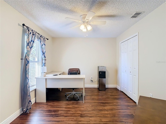 home office featuring a textured ceiling, dark hardwood / wood-style flooring, and ceiling fan