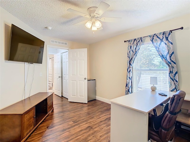 office space featuring ceiling fan, dark wood-type flooring, and a textured ceiling