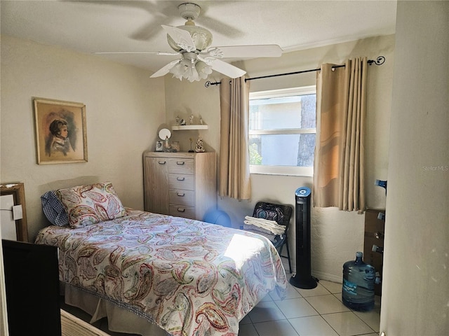 tiled bedroom featuring ceiling fan