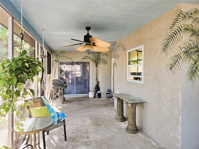 view of patio with ceiling fan and a grill