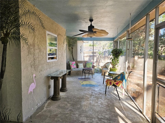 sunroom / solarium featuring ceiling fan