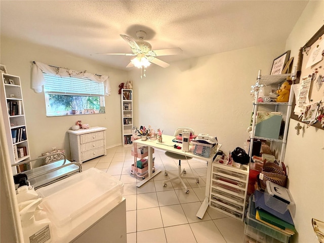 interior space with ceiling fan, a textured ceiling, and light tile patterned floors