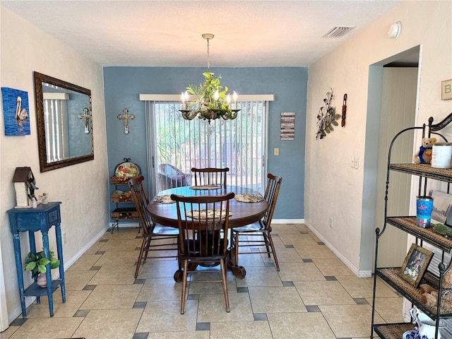 dining space featuring an inviting chandelier