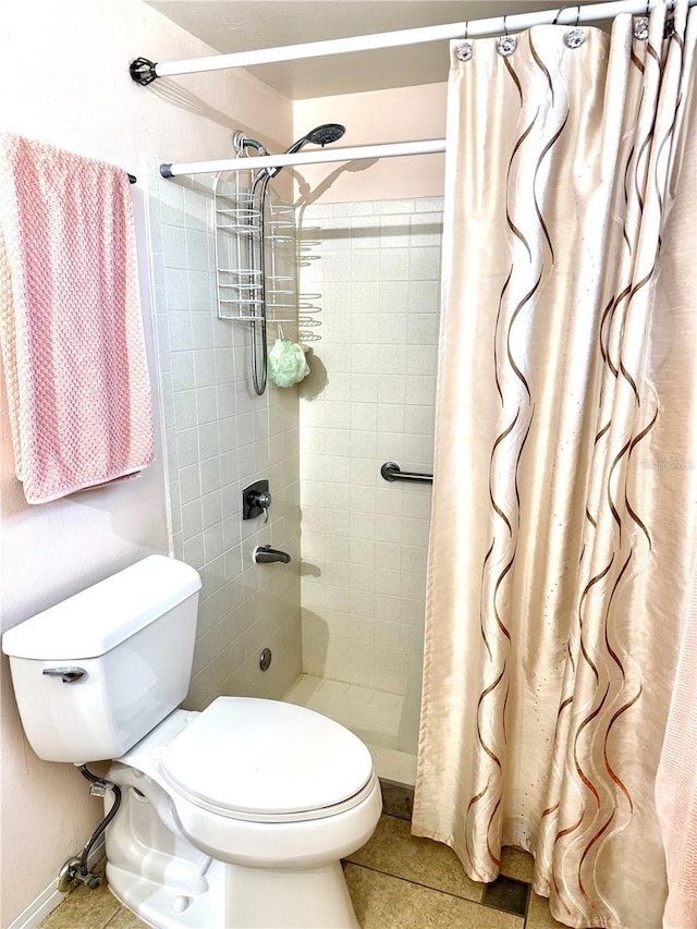 bathroom with tile patterned flooring, a shower with curtain, and toilet