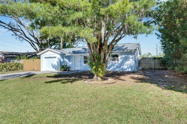 ranch-style home featuring a garage and a front yard