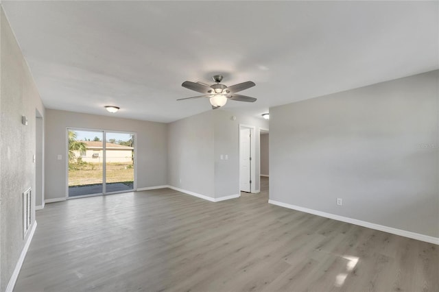 empty room with ceiling fan and light hardwood / wood-style floors