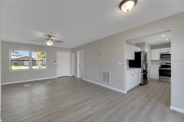 unfurnished living room featuring light hardwood / wood-style flooring and ceiling fan