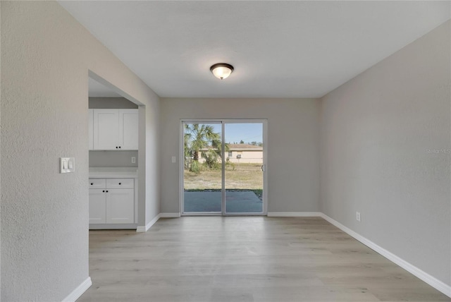 unfurnished room featuring light hardwood / wood-style floors