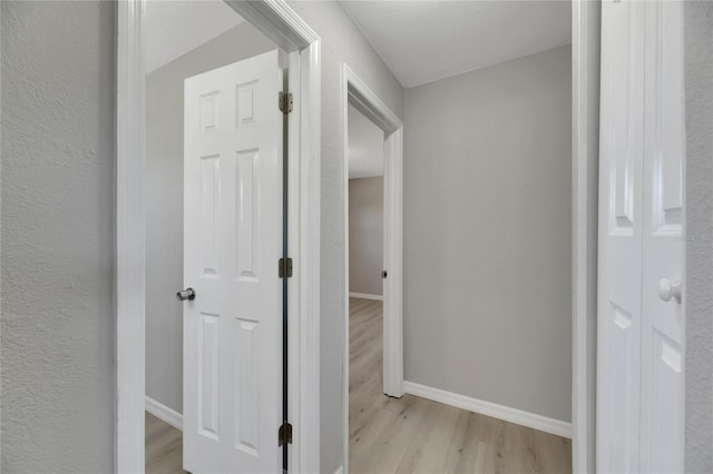 hallway with light hardwood / wood-style flooring