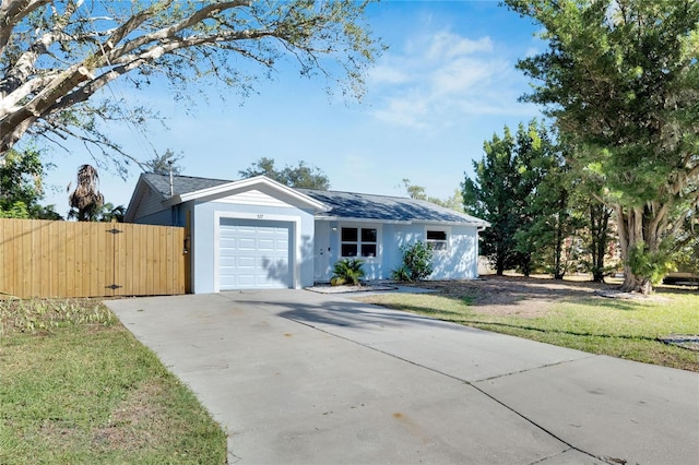 single story home featuring a front yard and a garage