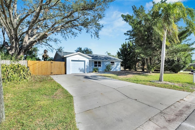 ranch-style home featuring a garage and a front lawn