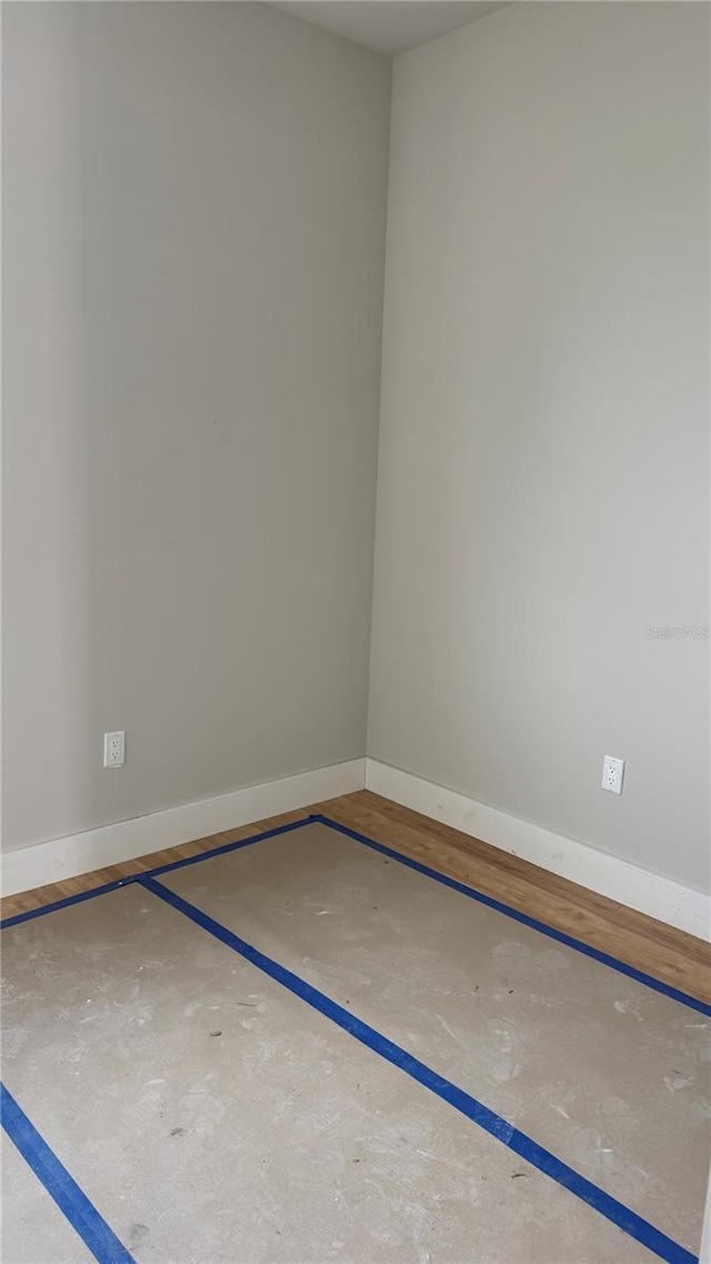 unfurnished room featuring baseboards