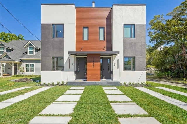 view of front of property with stucco siding and a front yard