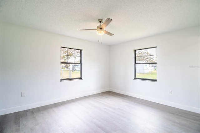 unfurnished room with a textured ceiling, ceiling fan, and hardwood / wood-style flooring