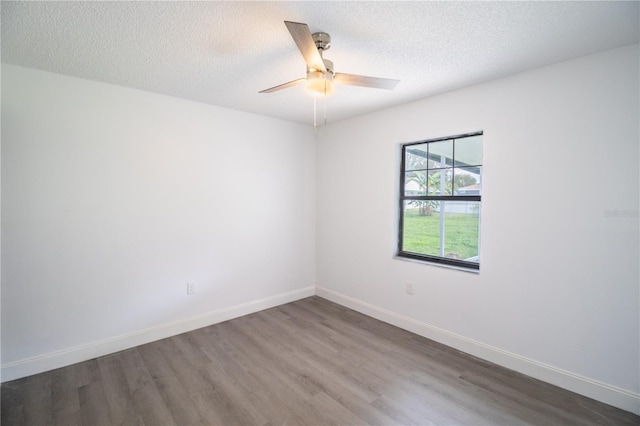 empty room with ceiling fan, a textured ceiling, and hardwood / wood-style flooring