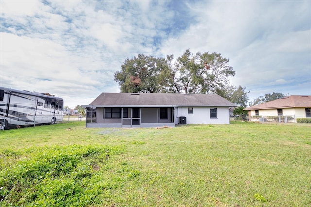 back of property featuring a lawn