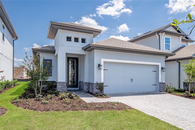 view of front of property with a garage and a front yard