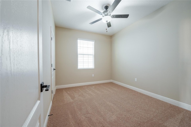 carpeted empty room featuring ceiling fan