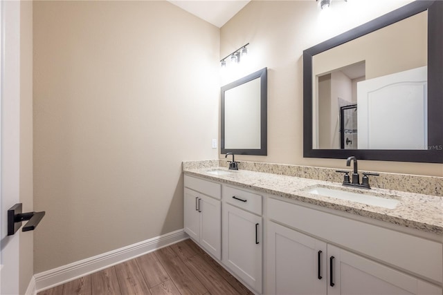 bathroom with hardwood / wood-style floors and vanity