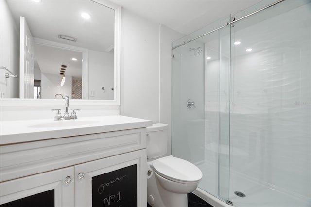 bathroom with vanity, toilet, and an enclosed shower