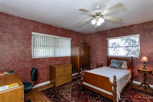 bedroom featuring ceiling fan and dark hardwood / wood-style floors