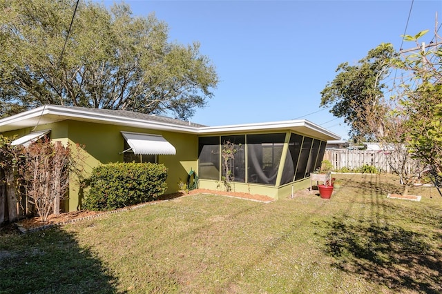 rear view of property featuring a lawn