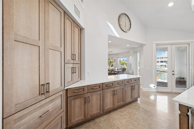 kitchen with lofted ceiling and french doors