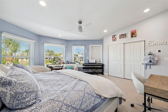 carpeted bedroom with ceiling fan and a closet