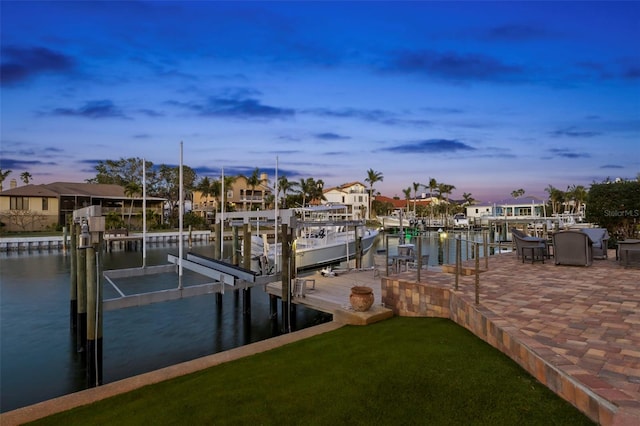 view of dock with a yard and a water view