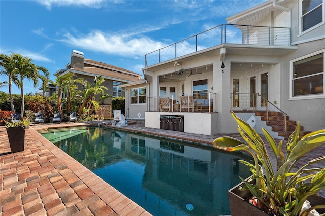 view of pool featuring a patio area and ceiling fan