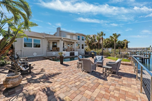 view of patio with an outdoor living space and a water view