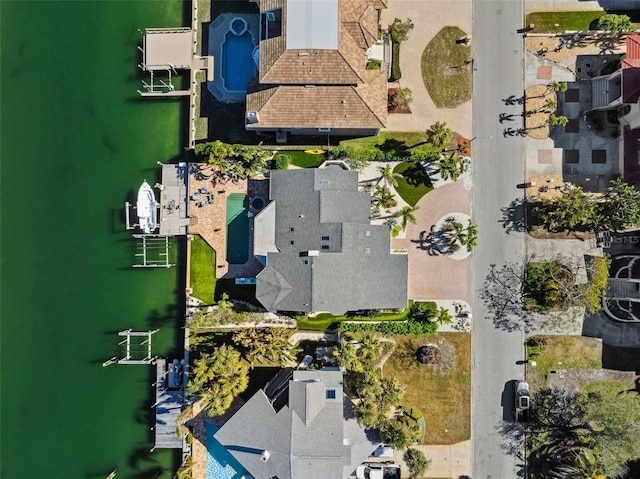 birds eye view of property with a water view