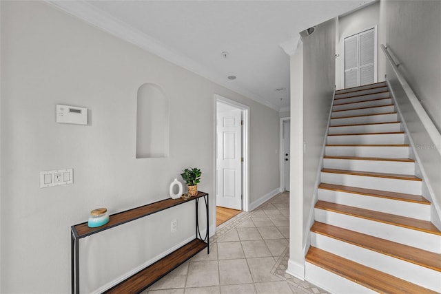 stairway featuring tile patterned flooring and crown molding