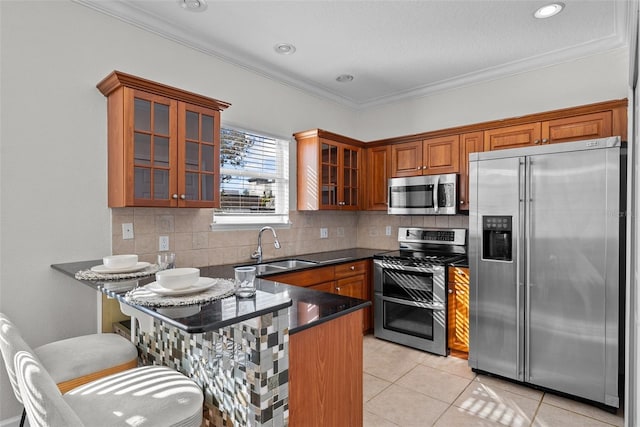 kitchen with sink, light tile patterned floors, ornamental molding, stainless steel appliances, and backsplash