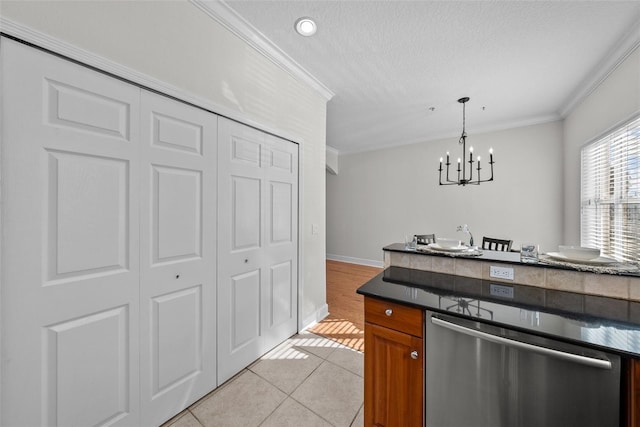 kitchen with a textured ceiling, hanging light fixtures, light tile patterned floors, ornamental molding, and dishwasher