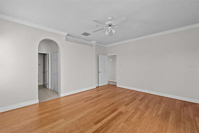 spare room featuring ornamental molding, ceiling fan, and light hardwood / wood-style flooring