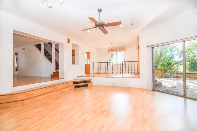 interior space featuring ceiling fan, plenty of natural light, and hardwood / wood-style flooring