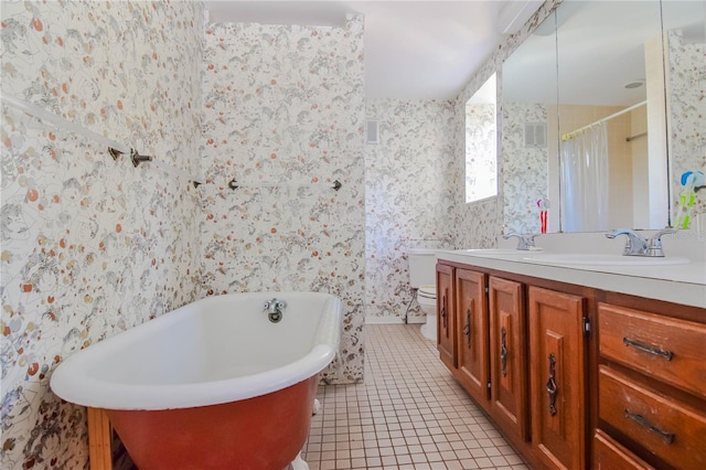 full bathroom with tile patterned floors, vanity, shower with separate bathtub, and toilet